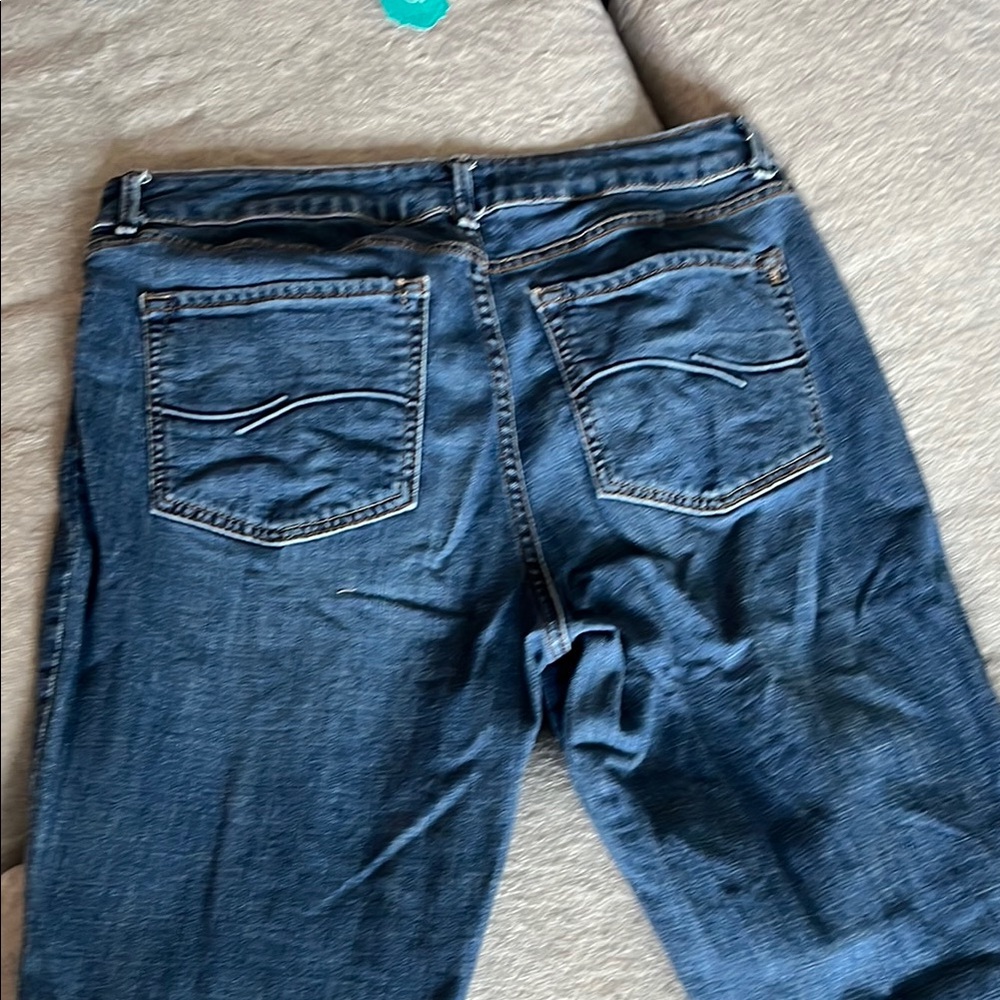 Blue Boot Cut Jeans with Distressed Details